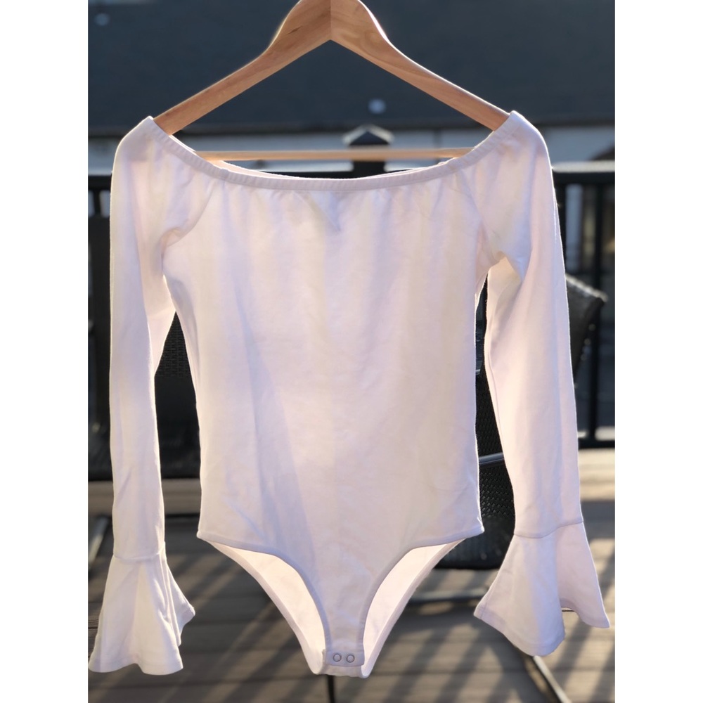 Off the shoulder white body suit.